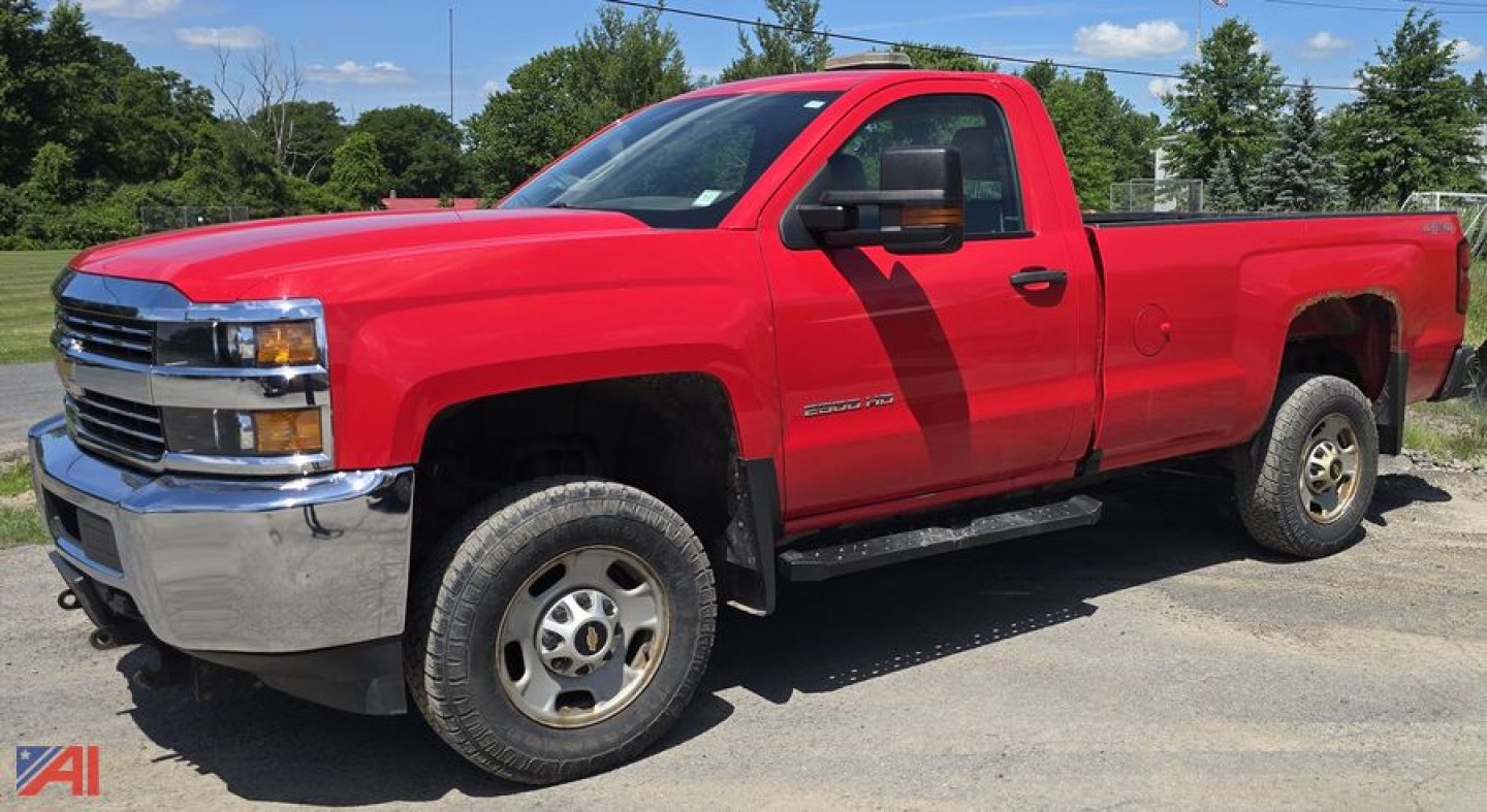 Red 2016 Chevrolet Silverado 2500HD pickup truck side view showing extended cab, long bed, black mirrors, and steel wheels.
