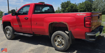 Red 2016 Chevrolet Silverado 2500HD pickup truck side rear view showing extended cab and long bed.