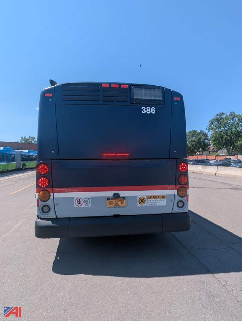 Bus rear view showing XD60 New Flyer transit bus with number 386 and CAUTION sticker on rear bumper.