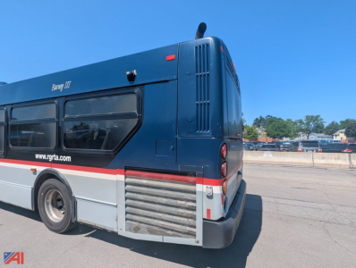 Bus rear quarter showing New Flyer XD60 transit bus with dark blue body, red stripe, rear engine access vents, and bumper.