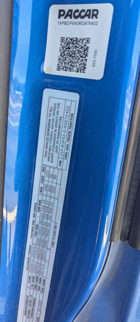 Peterbilt 579 door jamb/bumper area showing Paccar branding label and vehicle specs sticker.