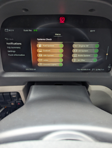 Peterbilt instrument cluster display showing Systems Check with green checkmarks for Fuel System, Coolant, ABS System, Axles, Exterior Lights, Engine Oil, Air System, Brake System, Air Filter, and other status items.