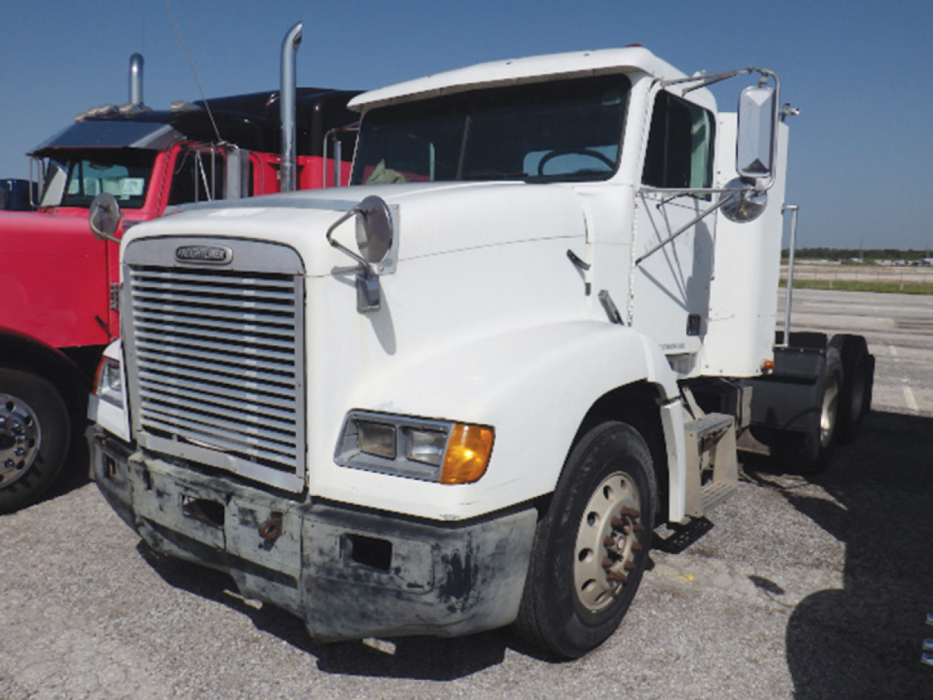 White 1998 Freightliner FLD112 Conventional Daycab showing front grille and headlights with bumper; dual rear axles and side mirrors.