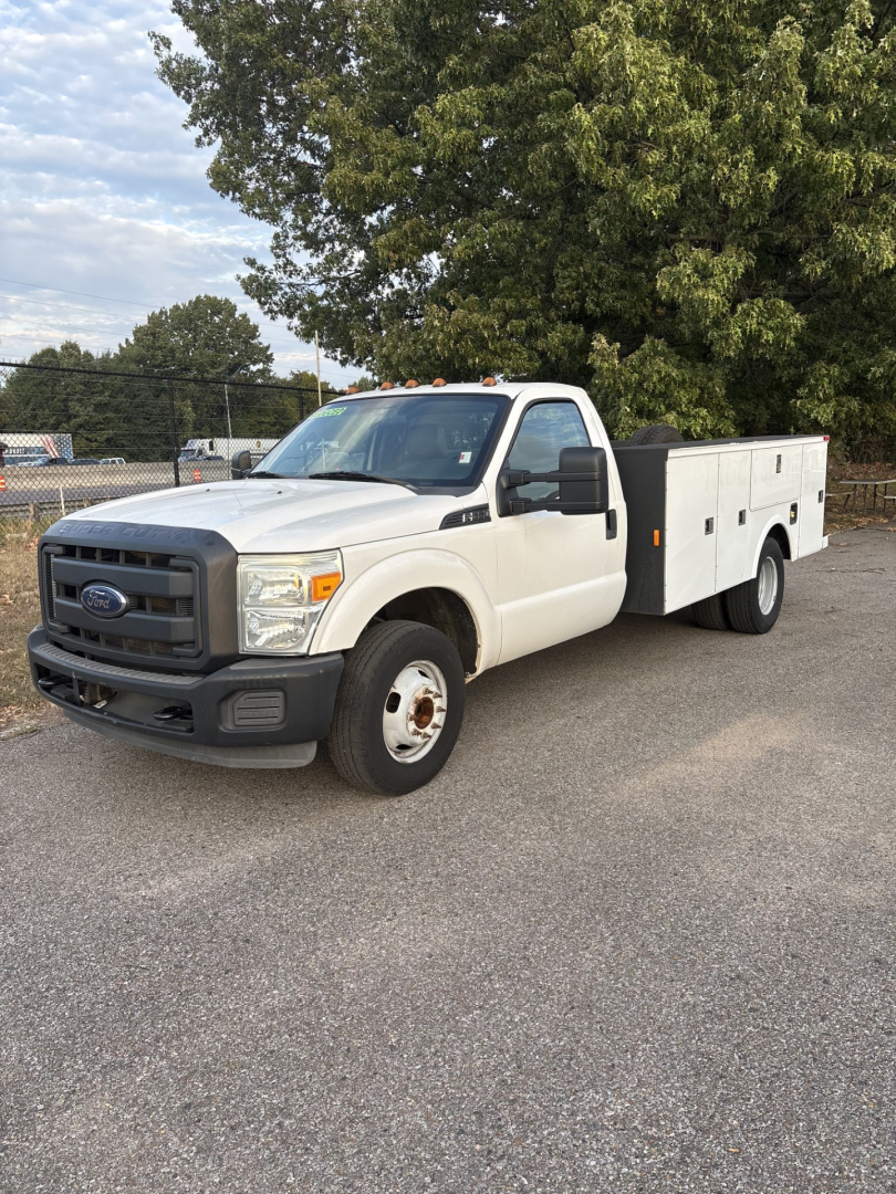 Ford F-350 cab and chassis utility body truck, white, front three-quarter view showing stock utility compartments on bed side, black grille, clean body panels.