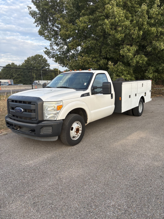 Ford F-350 cab and chassis utility body truck, white, front three-quarter view showing stock utility compartments on bed side, black grille, clean body panels.