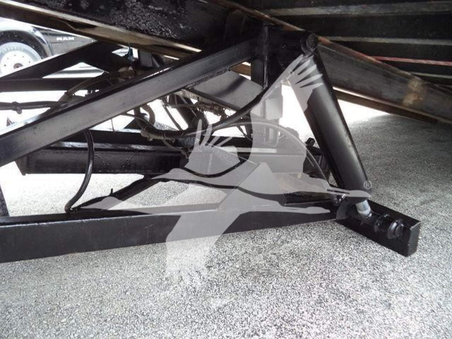 Truck chassis and hitch components of a 2006 Freightliner M2 106 roll-off chassis showing frame and supports.