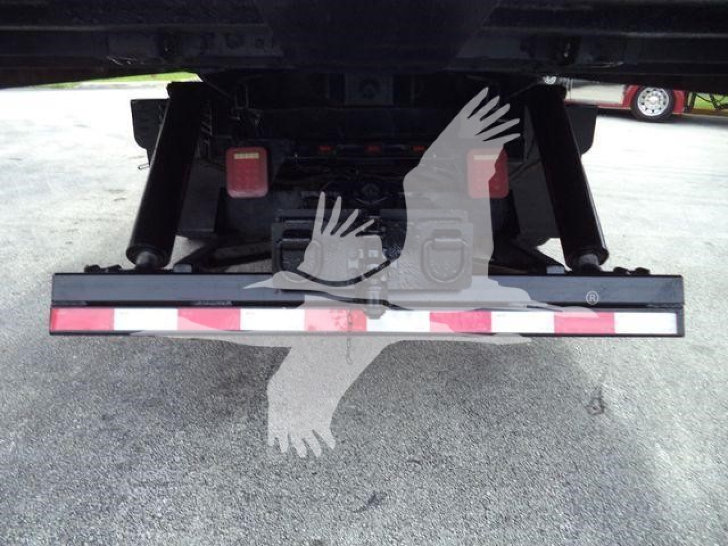 Rear view of Freightliner M2 106 roll-off truck showing rear bumper and tail lights