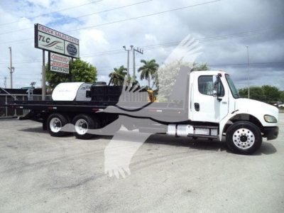 Rolloff truck chassis and flatbed on a Freightliner M2 106, side view showing cab, dual rear axles, and long flatbed.