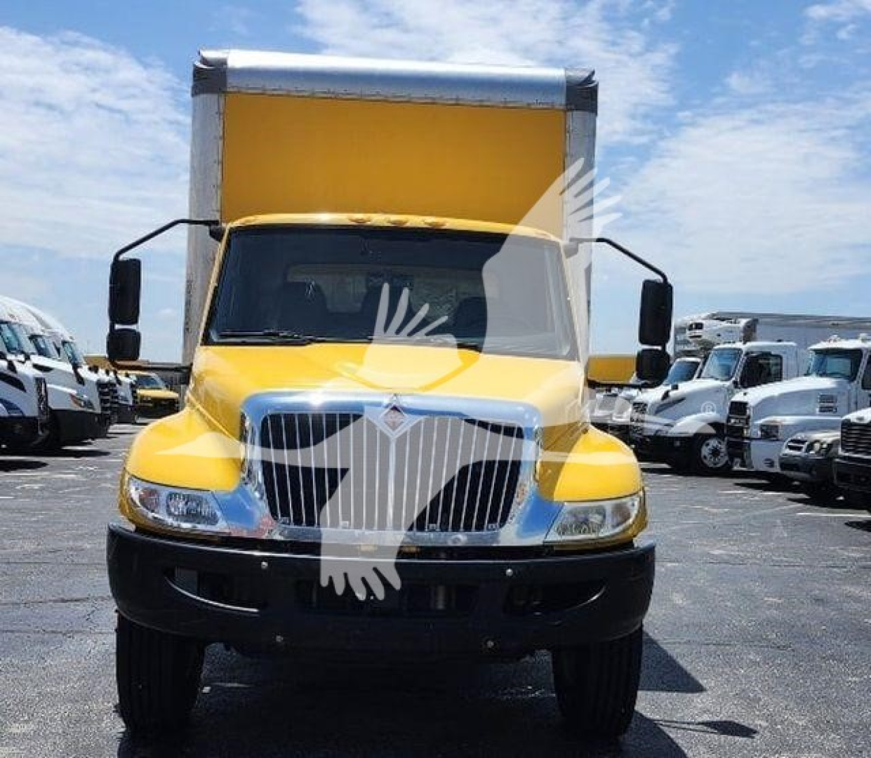 Front view of a yellow 2021 International MV box truck, with large grille and raised cargo box; headlights, mirrors, and bumper visible.
