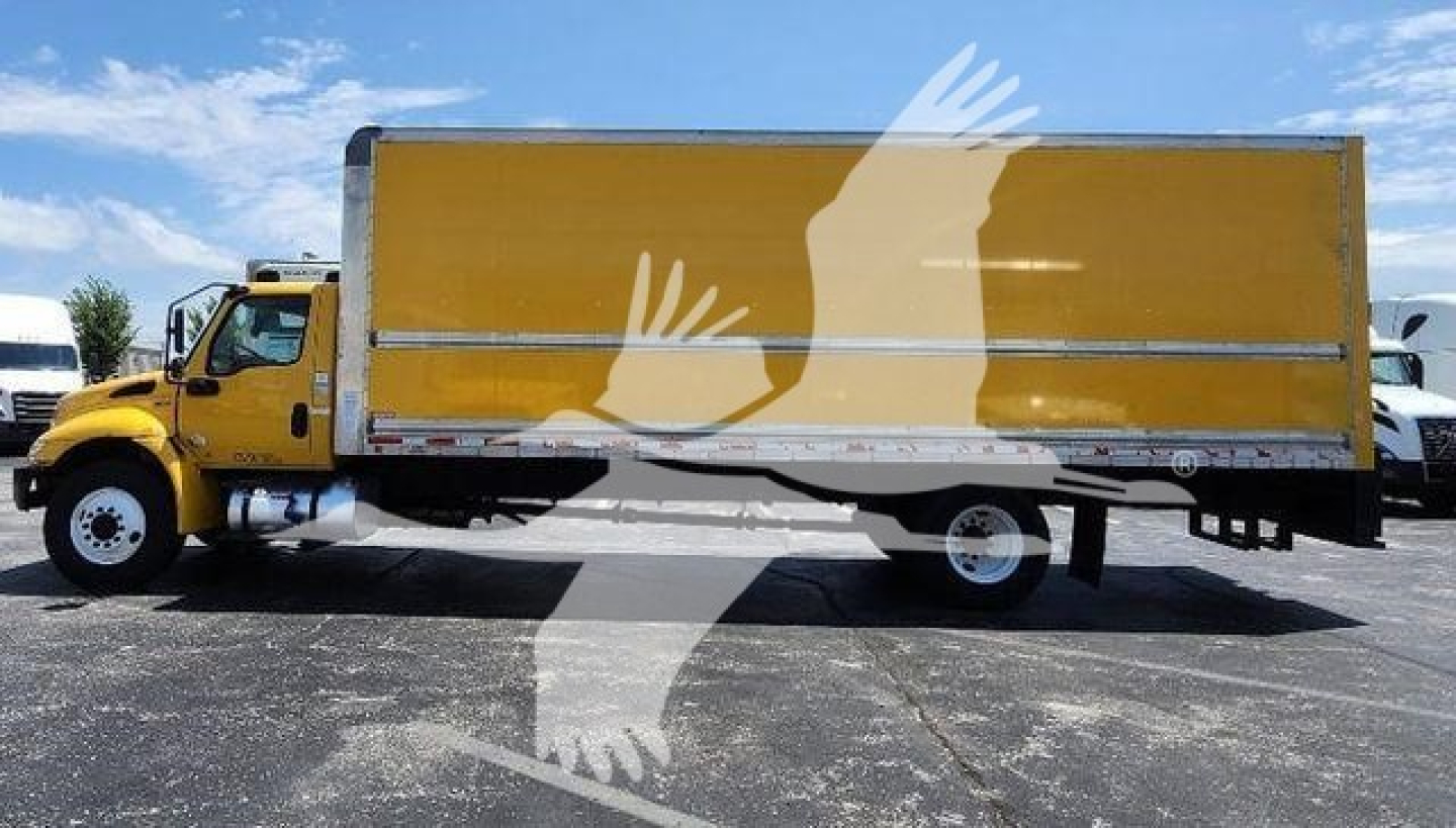 Truck side view showing a yellow International MV box truck with a large cargo box and wheels visible.