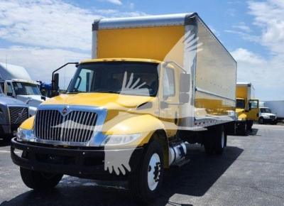 Box truck showing front and side view of a yellow 2021 International MV with a large box cargo area.