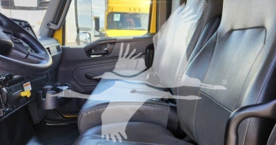 Truck cab interior view of 2021 International MV showing front seats and dashboard with steering wheel.