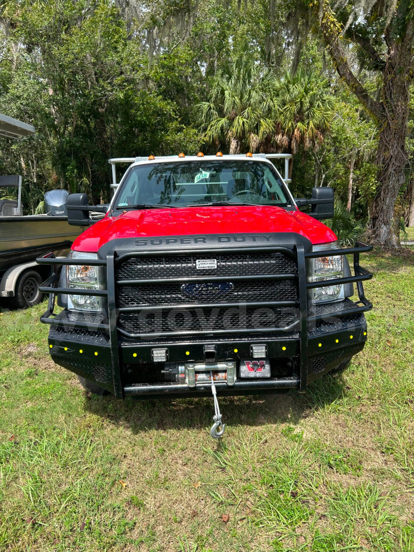 Ford F-550 service/utility truck front view with heavy bumper guard, winch, and yellow marker lights.