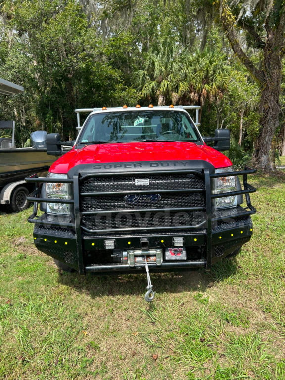 Ford F-550 service/utility truck front view with heavy bumper guard, winch, and yellow marker lights.