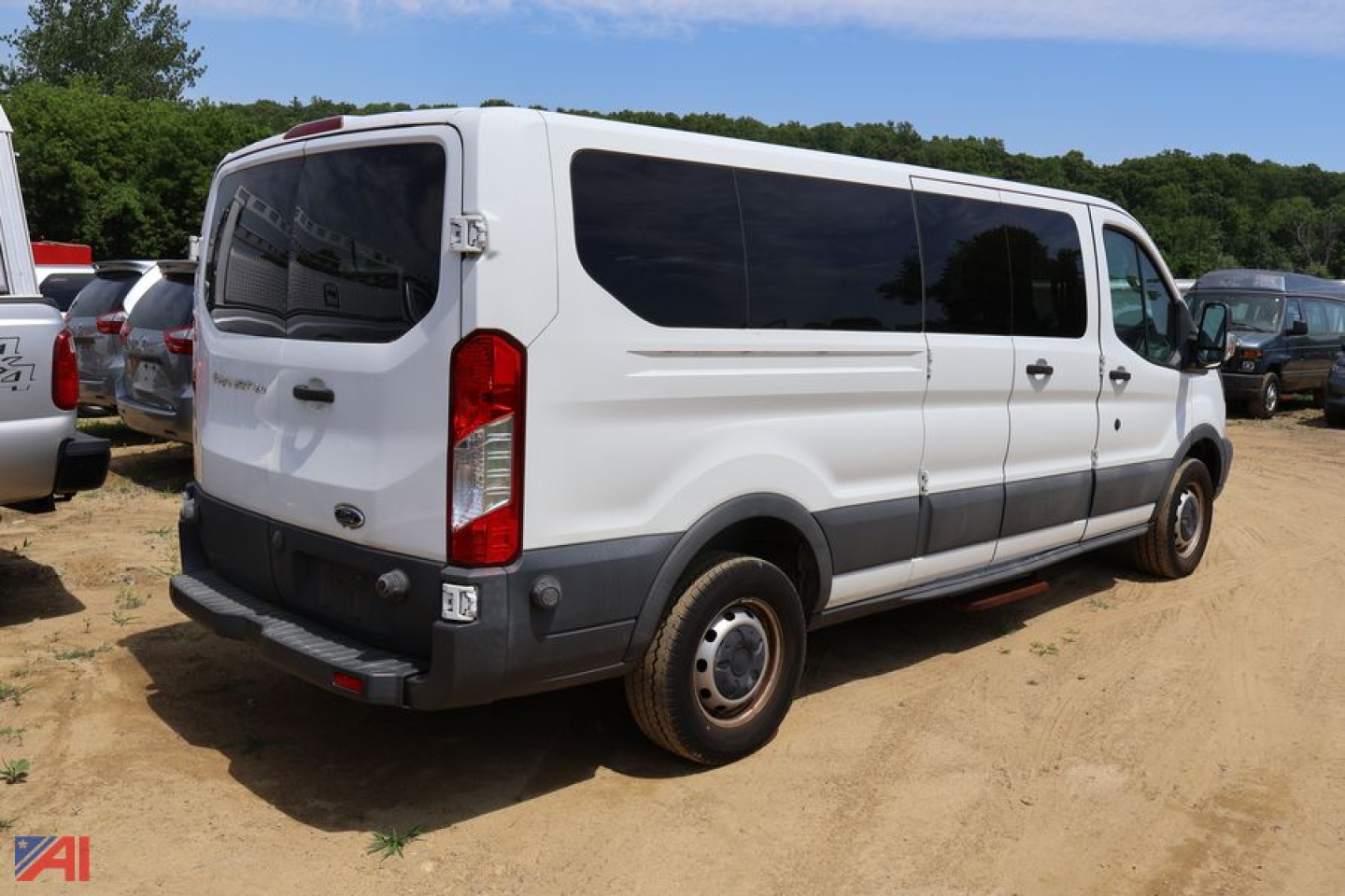 Ford Transit 350 cargo van rear view showing side and back with black trim and tinted windows.
