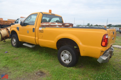 Ford F-250 Super Duty pickup with plow attachment in yellow, side view showing cab, bed, and rear bumper.