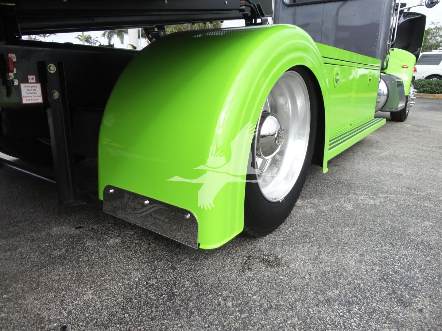 Peterbilt 337 rollback truck wheel and bright green fender viewed from rear side showing lime green paint and chrome wheel hub
