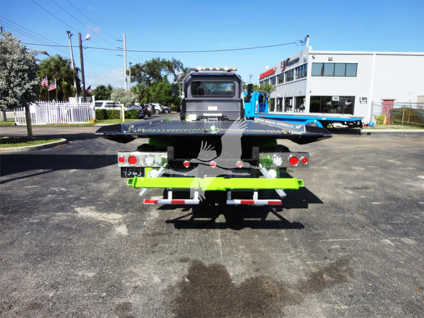 Peterbilt 337 rollback truck rear view showing flatbed and rear lighting.