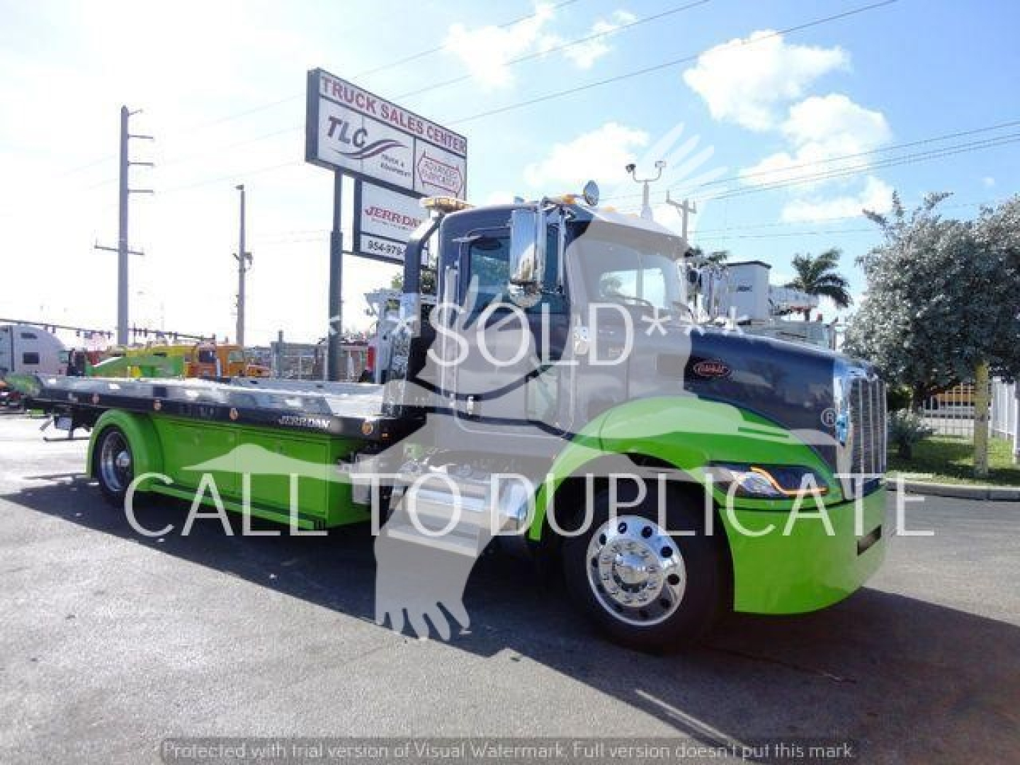 Peterbilt 337 rollback truck in green and black, side view with bed extended, watermark 'SOLD' across image.