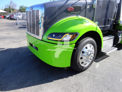Peterbilt 337 truck front fender and grille with green bumper and chrome wheel showing