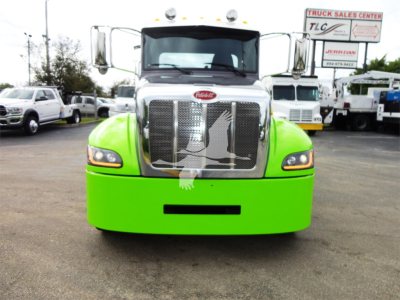 Green Peterbilt 337 truck front view with chrome grille and silver hood, rounded bumper, and side mirrors.