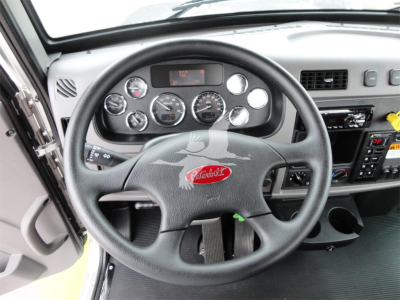 Peterbilt air-brake truck interior showing steering wheel and dashboard gauges.
