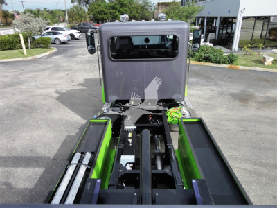 Peterbilt 337 rollback truck frame and cab from rear/upper view showing green accents and hydraulic components.