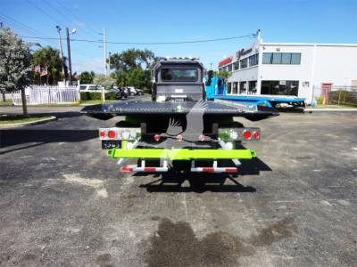 Peterbilt 337 rollback truck rear view showing flatbed and rear lighting.