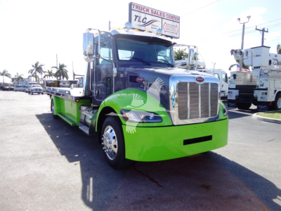 Peterbilt 337 rollback truck with bright green front and chrome grille, front view.