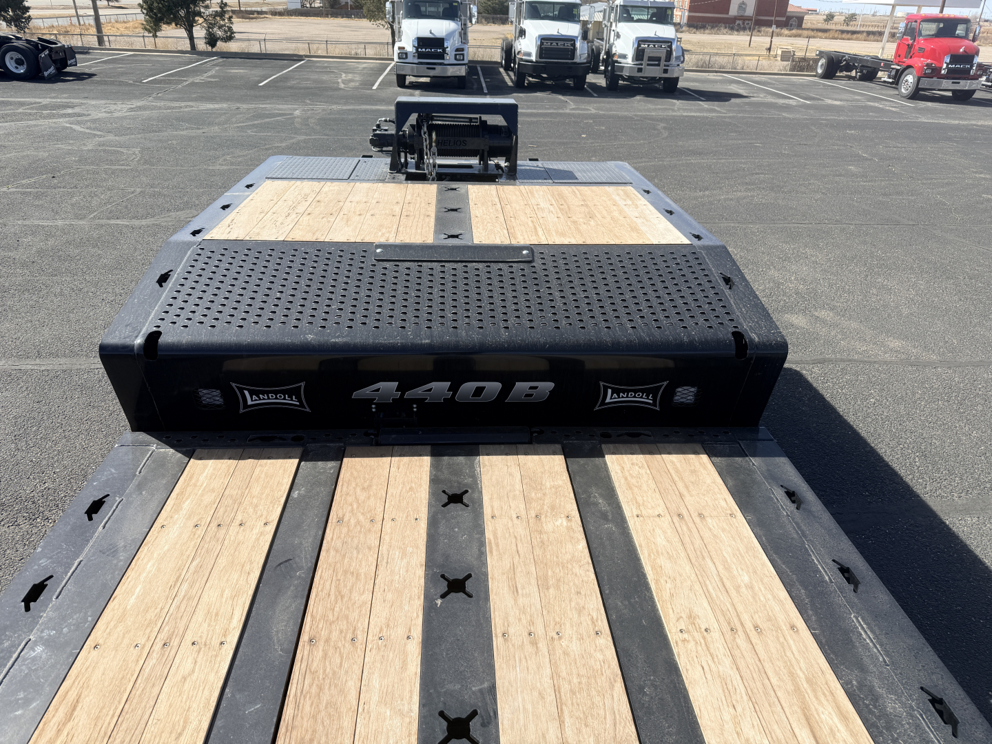 Landoll 440B-53 40 Ton slide axle trailer deck with wood planks and black steel frame, front plate with 440B branding.