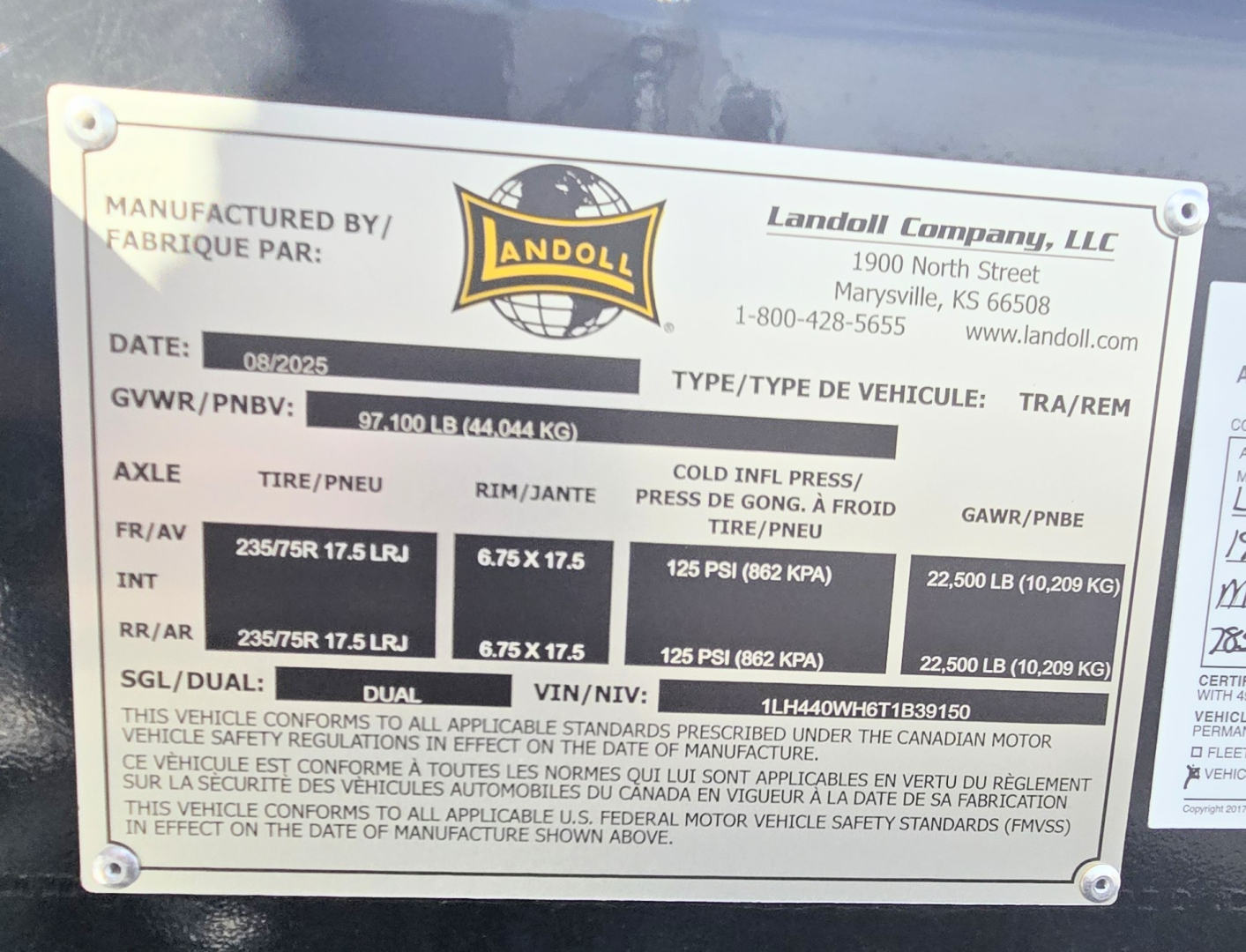 Landoll 40 ton slide axle trailer data plate showing manufacturer details, weights, tire specs, and VIN.