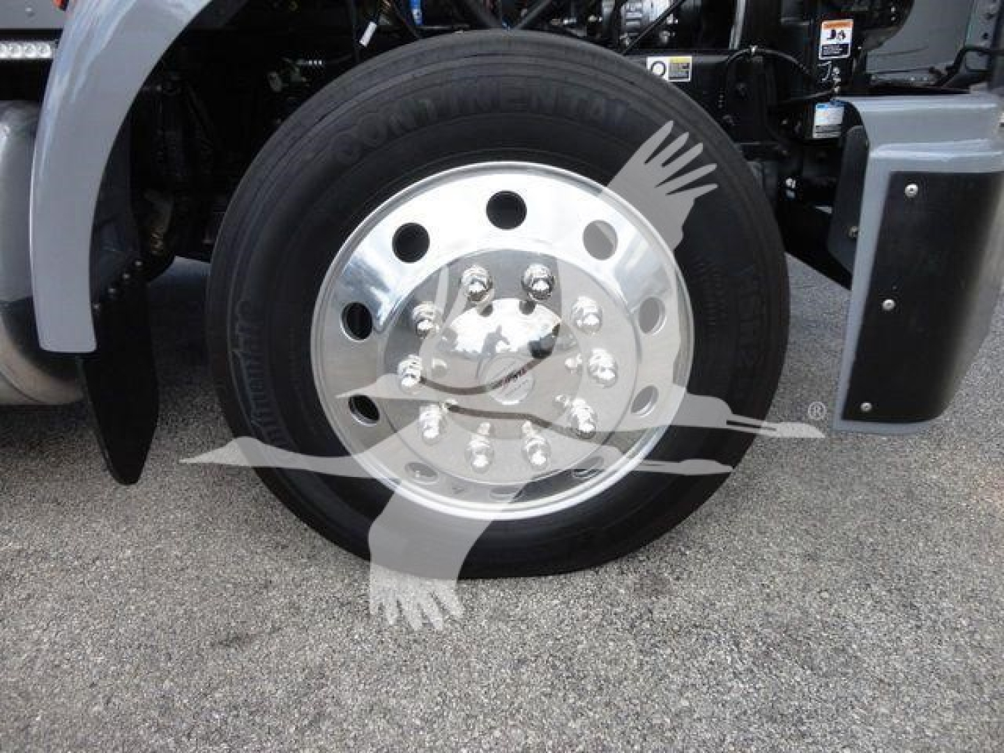 Peterbilt 337 wheel and front fender showing aluminum dual rear wheels and hub with lug nuts.