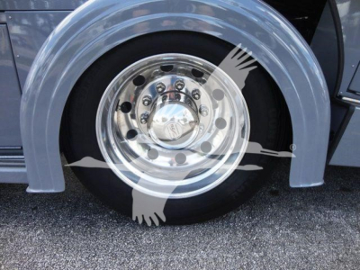 Trucks wheel area showing polished aluminum front wheel with multiple lug nuts; fender and tire visible.
