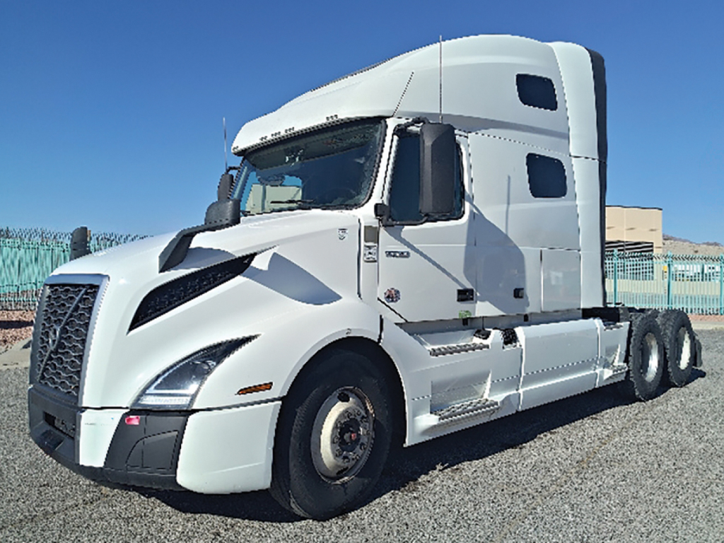Volvo VNL 760 sleeper tractor in white, front-left view with cab and twin rear axles, no visible text other than generic truck features.
