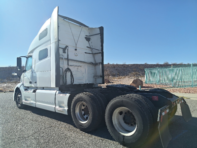 Truck side view of a 2022 Volvo VNL 760 semi tractor showing sleeper cab and rear wheels.