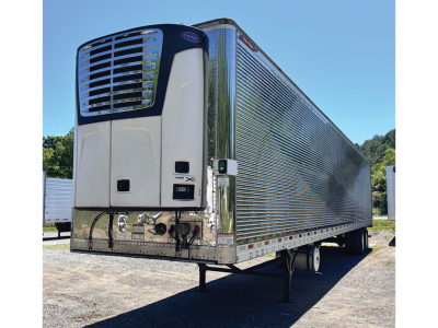 Great Dane Everest CL refrigerated trailer with a white front refrigeration unit and chrome corrugated aluminum body, parked on dirt lot.