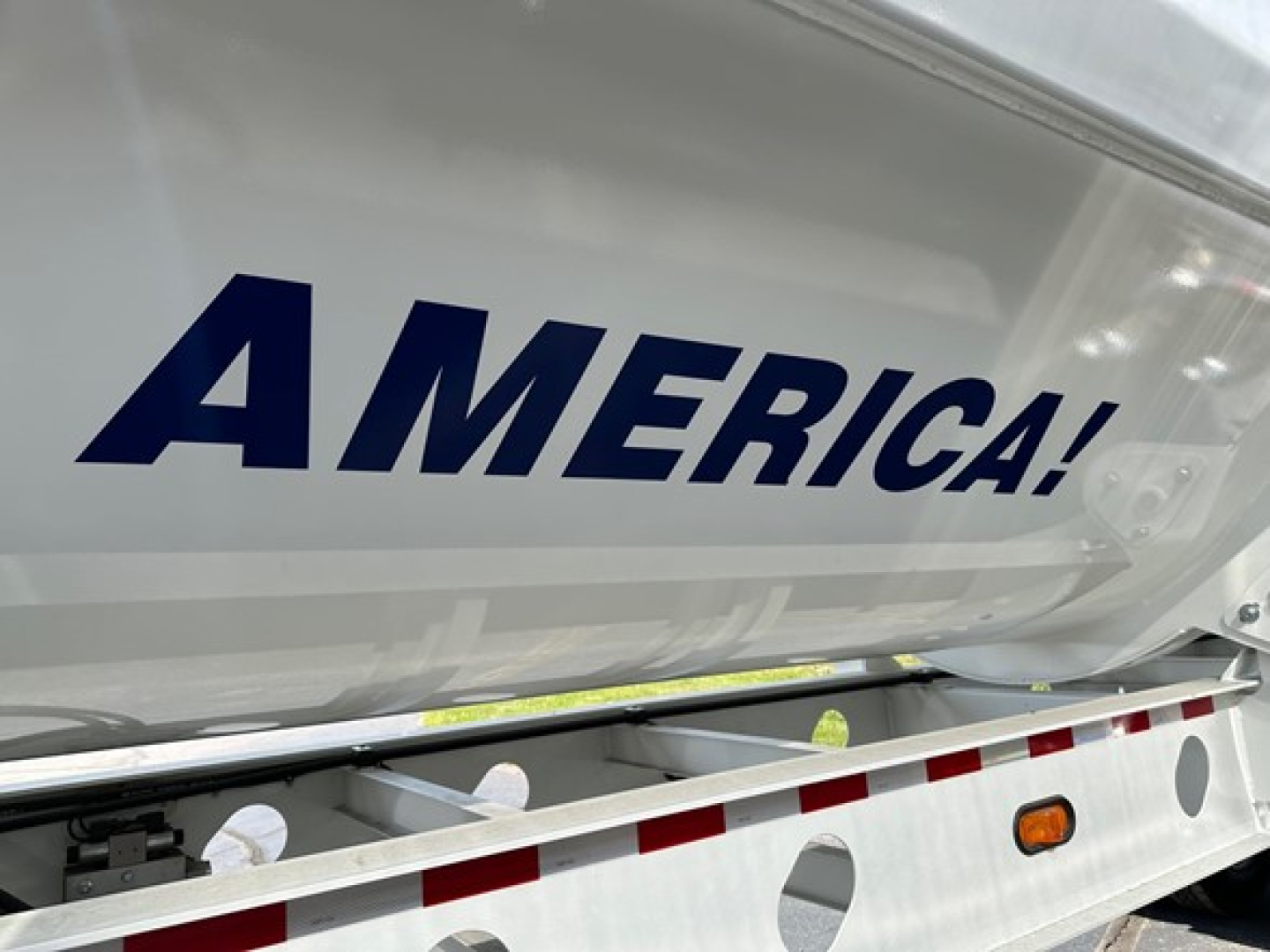 Trailer side showing AMERICA! branding on the side of a Jet side-dump trailer.