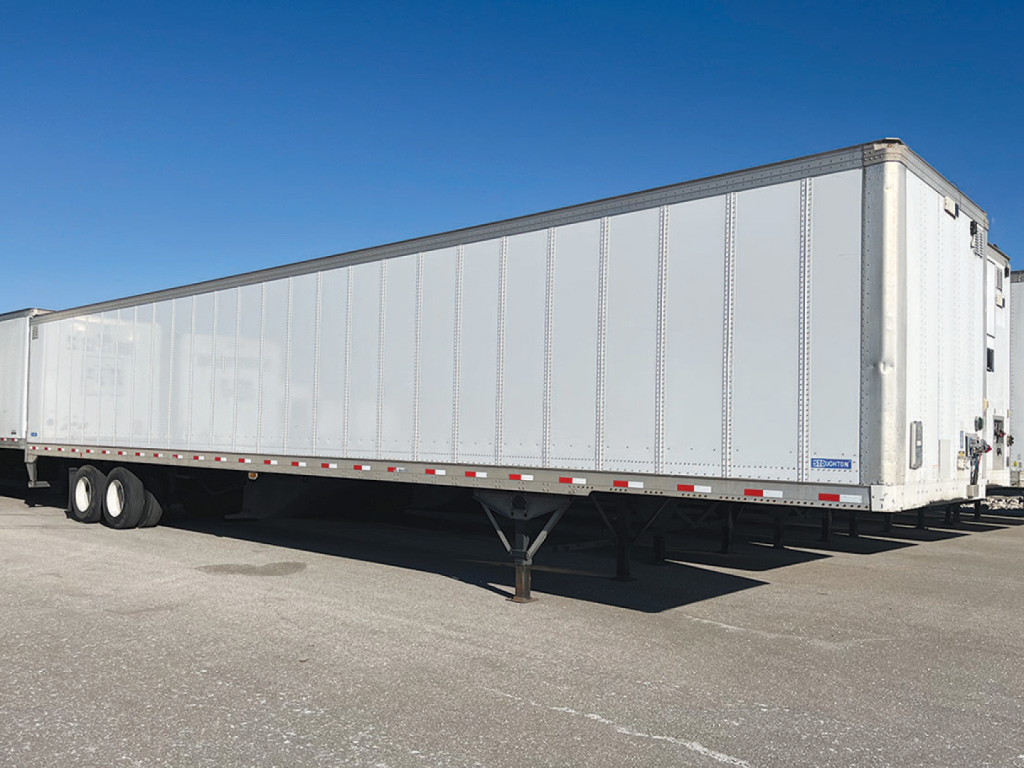 Trailer side view showing a long white Stoughton Z-Plate van trailer with tandem wheels and landing gear, stock number 551297, VIN 1DW1A5325KBA13472.
