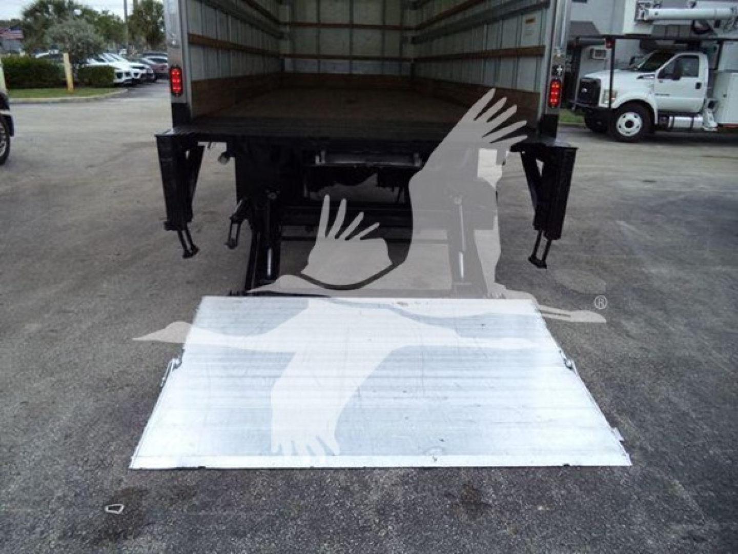 Truck rear showing aluminum loading ramp extended from back of 2019 International Durastar 4300 box truck.
