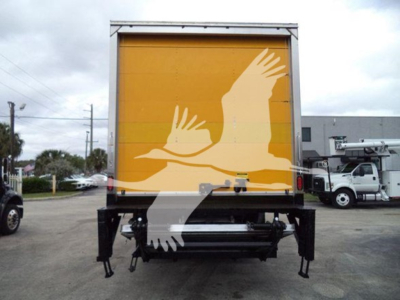 Back of 2019 International Durastar 4300 box truck with yellow cargo area, rear liftgate, and black undercarriage.