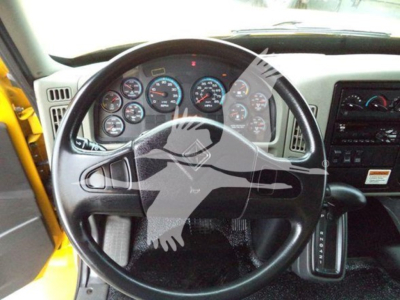 Dashboard view of 2019 International Durastar 4300 showing steering wheel, gauges, and gear selector.