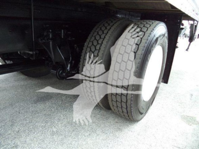 Truck rear dual tires and suspension undercarriage showing dual wheel setup and axles.