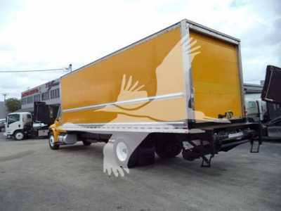 Box truck with yellow cargo box and white chassis, International Durastar 4300, side view showing cargo box and rear underride area