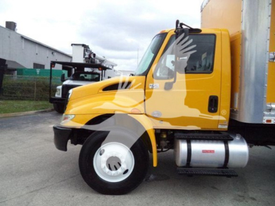 Truck side view showing 2019 International Durastar 4300 box truck in yellow with silver fuel tank and black tires.