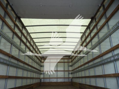 Box truck interior cargo bay with metal tie rails and wooden floor; empty, seen from rear doors perspective.
