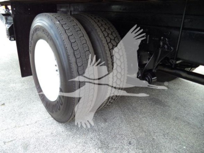 Left rear dual tires on International Durastar 4300 box truck showing dual axle configuration and undercarriage components.