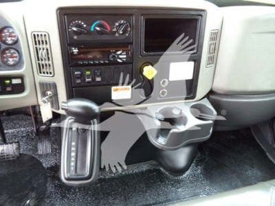 Front interior of a 2019 International Durastar 4300 cab showing steering column, gear shifter, dashboard gauges, controls, and a cup holder.