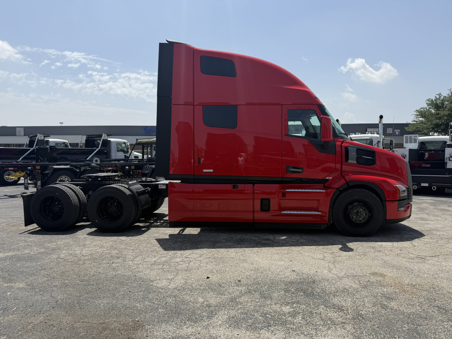 Mack PR64T76H conventional sleeper truck in red, side profile view, dual rear axles, highway tractor chassis, cargo area not attached.
