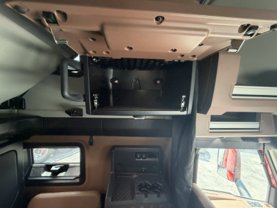 Mack PR64T76H cab interior showing overhead sleeper area with storage compartments and dashboard area visible.