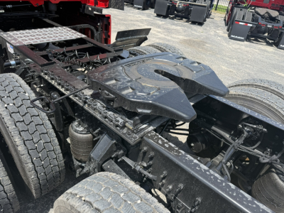Mack PR64T76H truck chassis showing fifth wheel and drivetrain components, dual rear axles, and fuel/air lines visible.